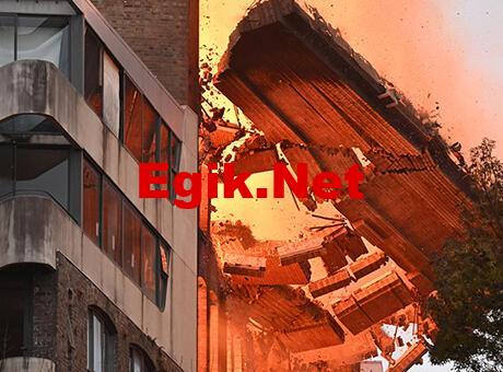 Alevlerin sardığı binanın duvarı bir anda yıkıldı